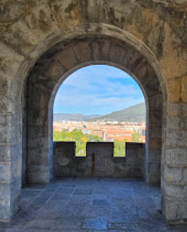 Distant hills through arch in city wall