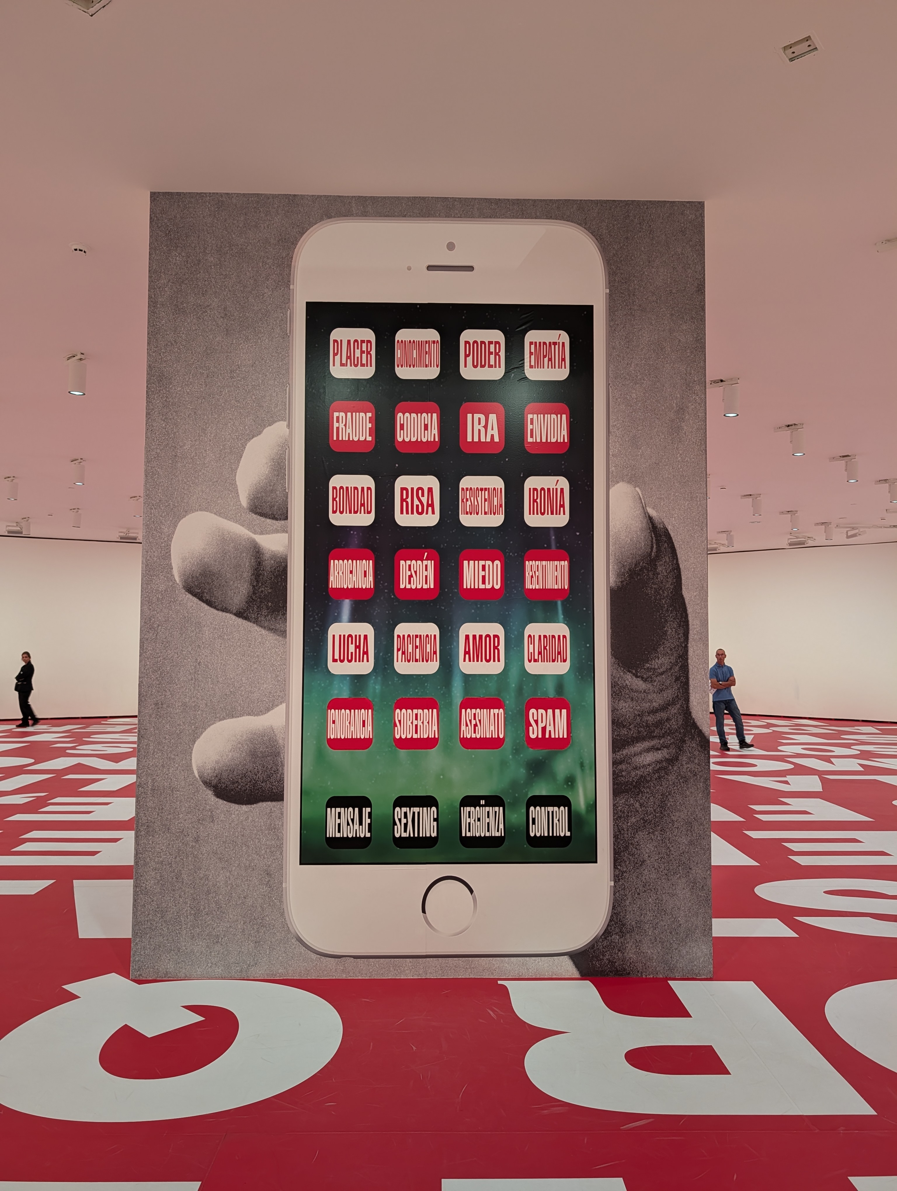 Image from Barbara Kruger exhibit, cell phone with words on icons