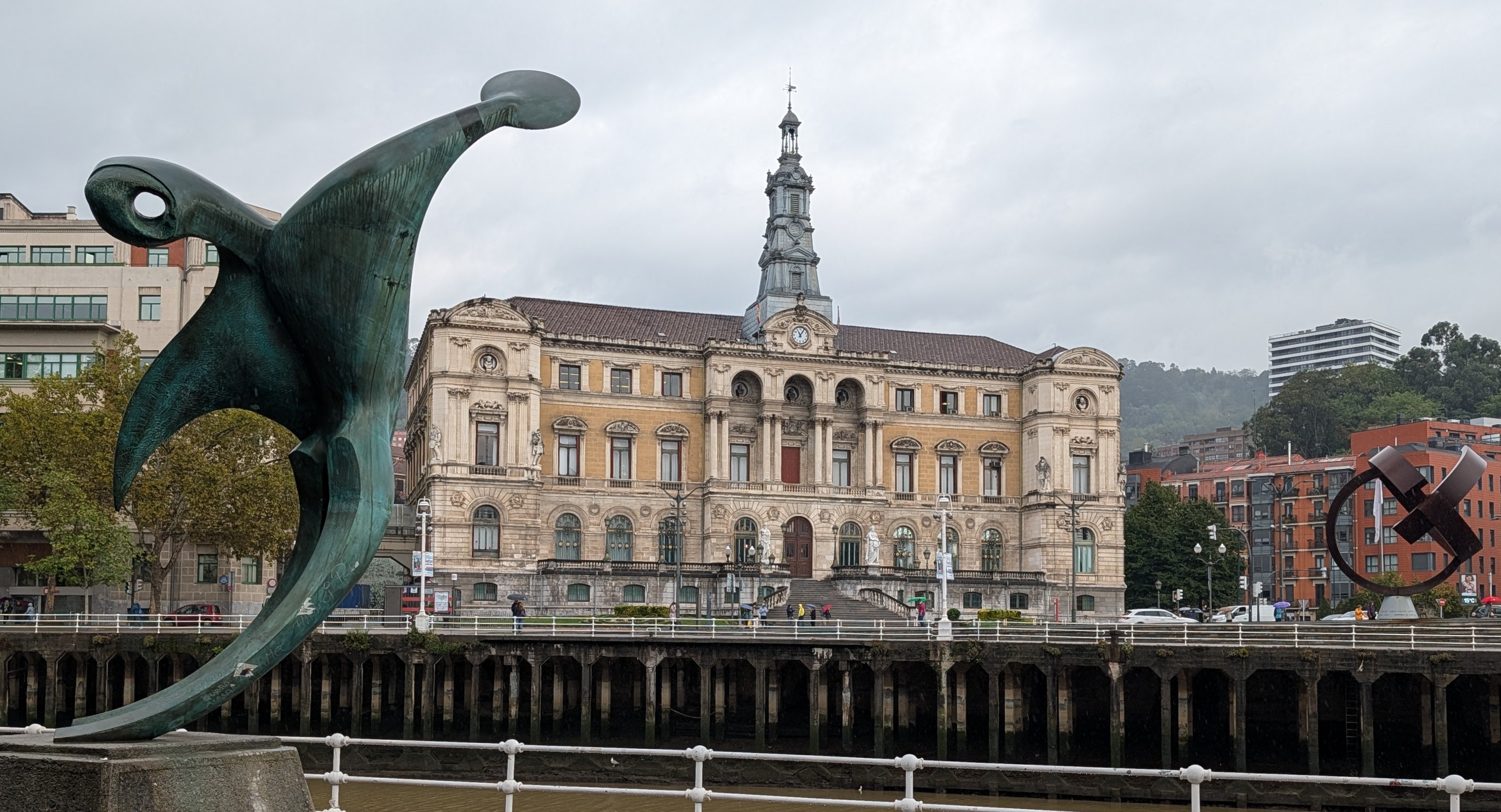 Bilbao City Hall framed by large sculptures.