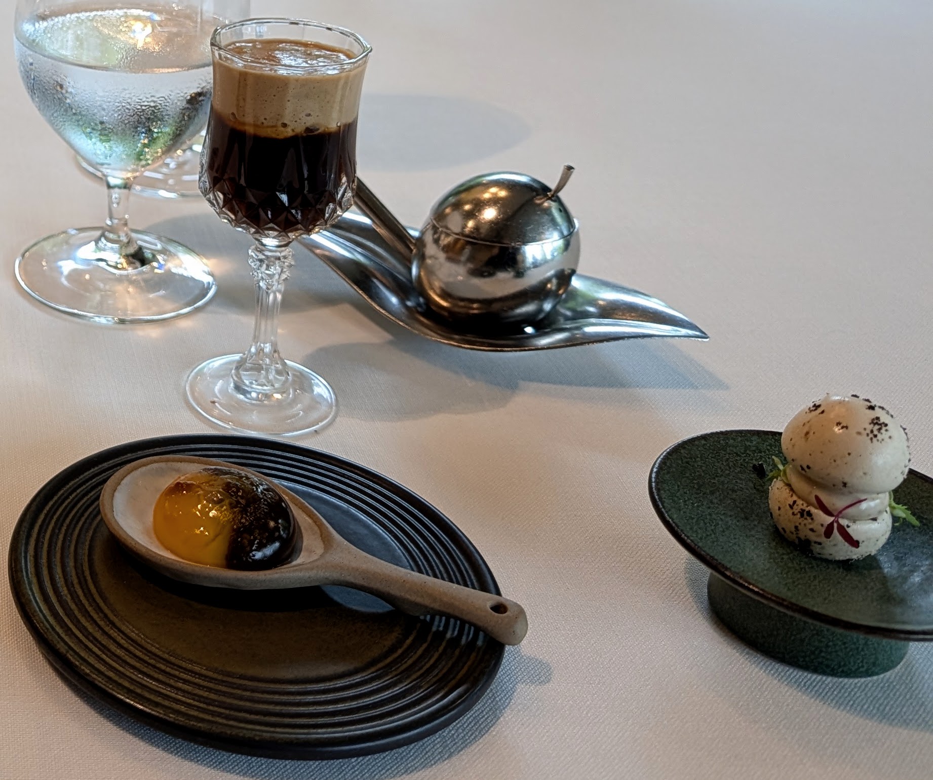 Small bites and mushroom broth in a glass