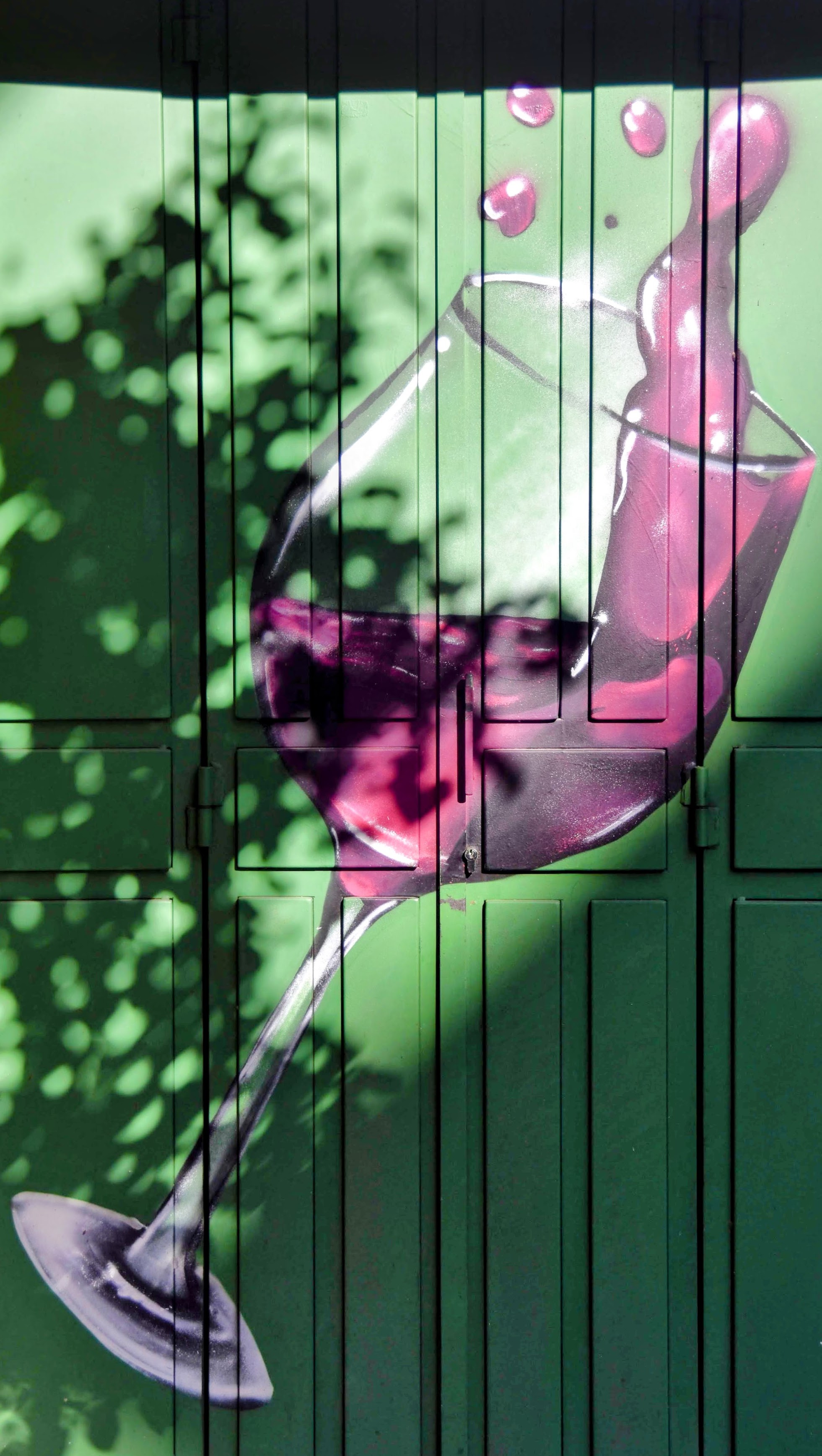 Wine glass mural on green wall