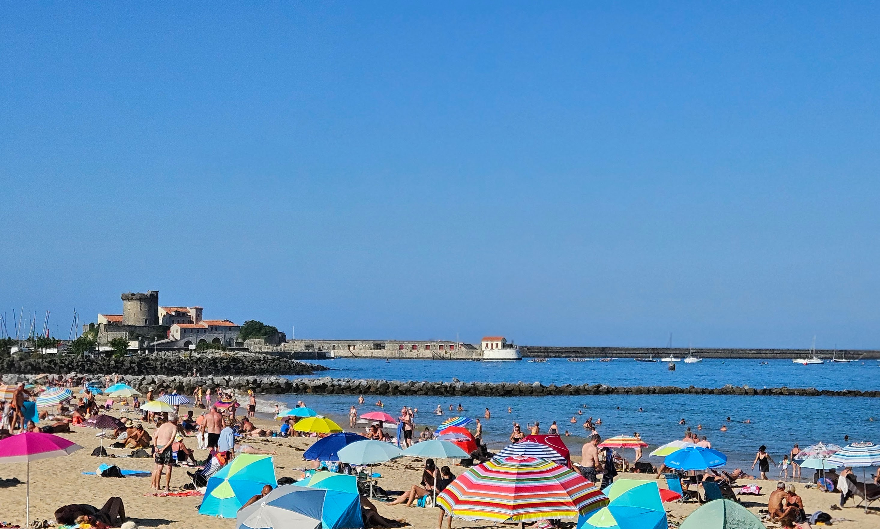 Crowded beach in front of Fort de Socoa, Ciboure, France