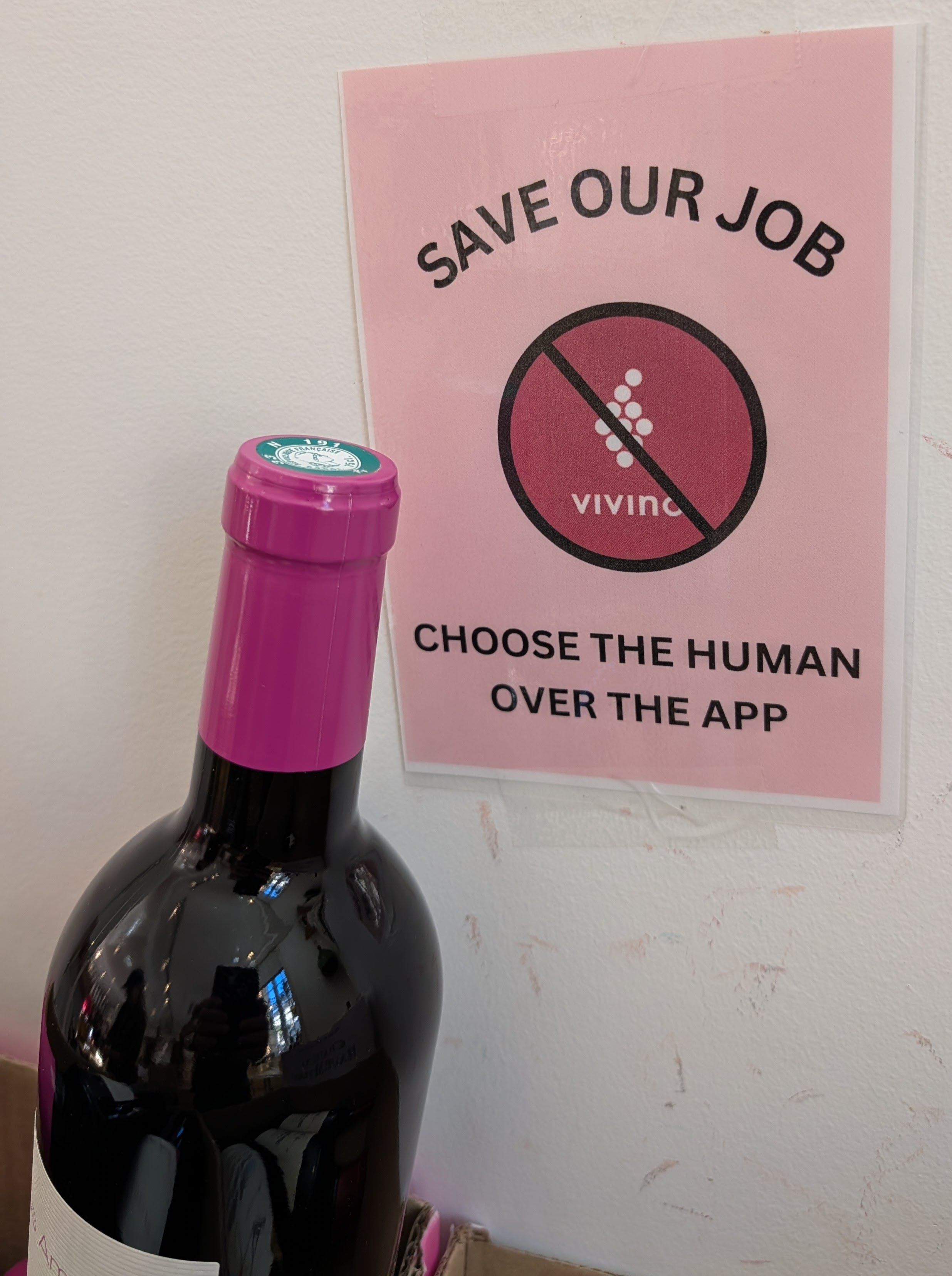 Sign encouraging people to ask about wines instead of using apps