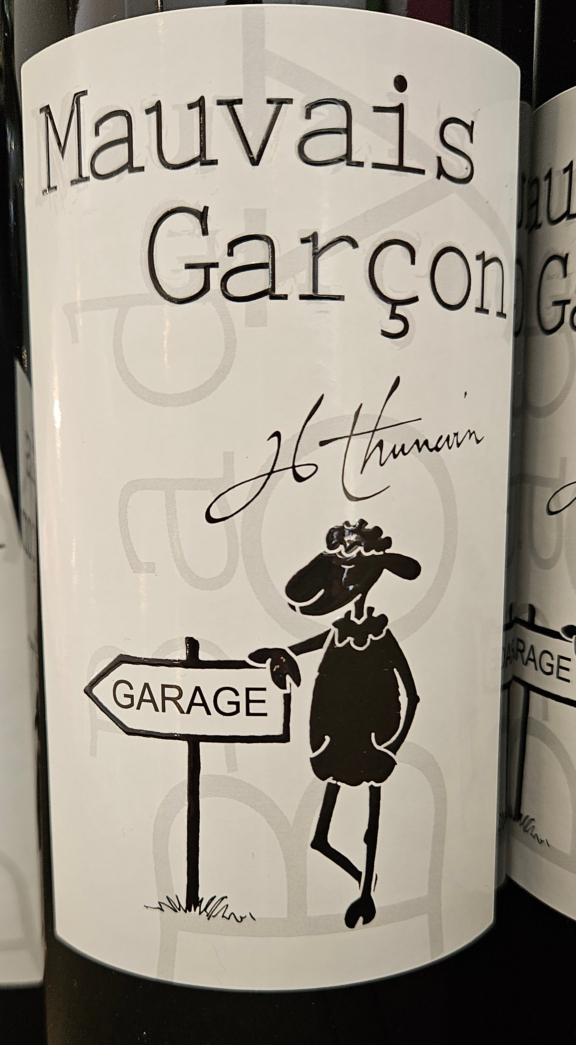 Wine label with cute sheep leaning on sign pointing to the Garage
