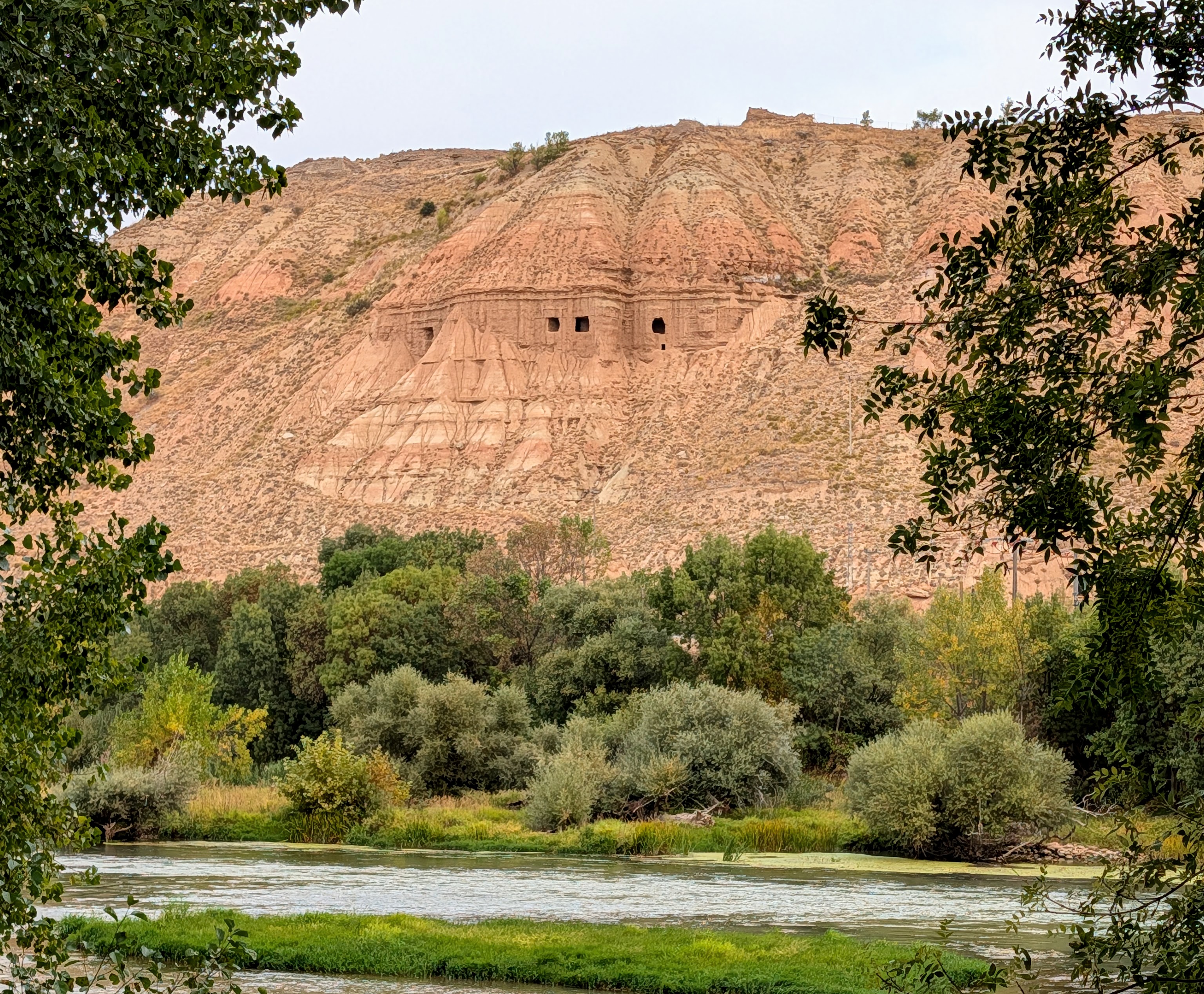 Caves are visible in the cliffs above the park