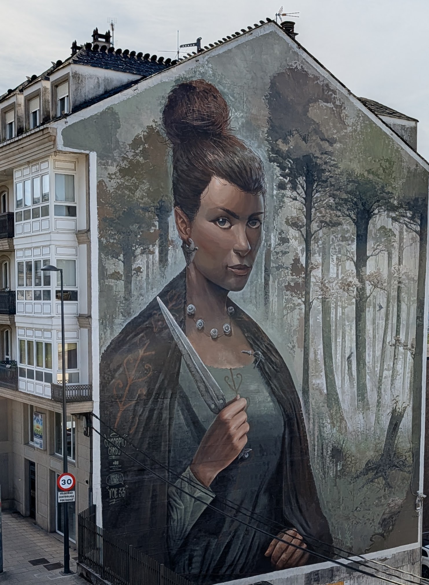Mural of woman, maybe an elf, holding a knife, in Lugo