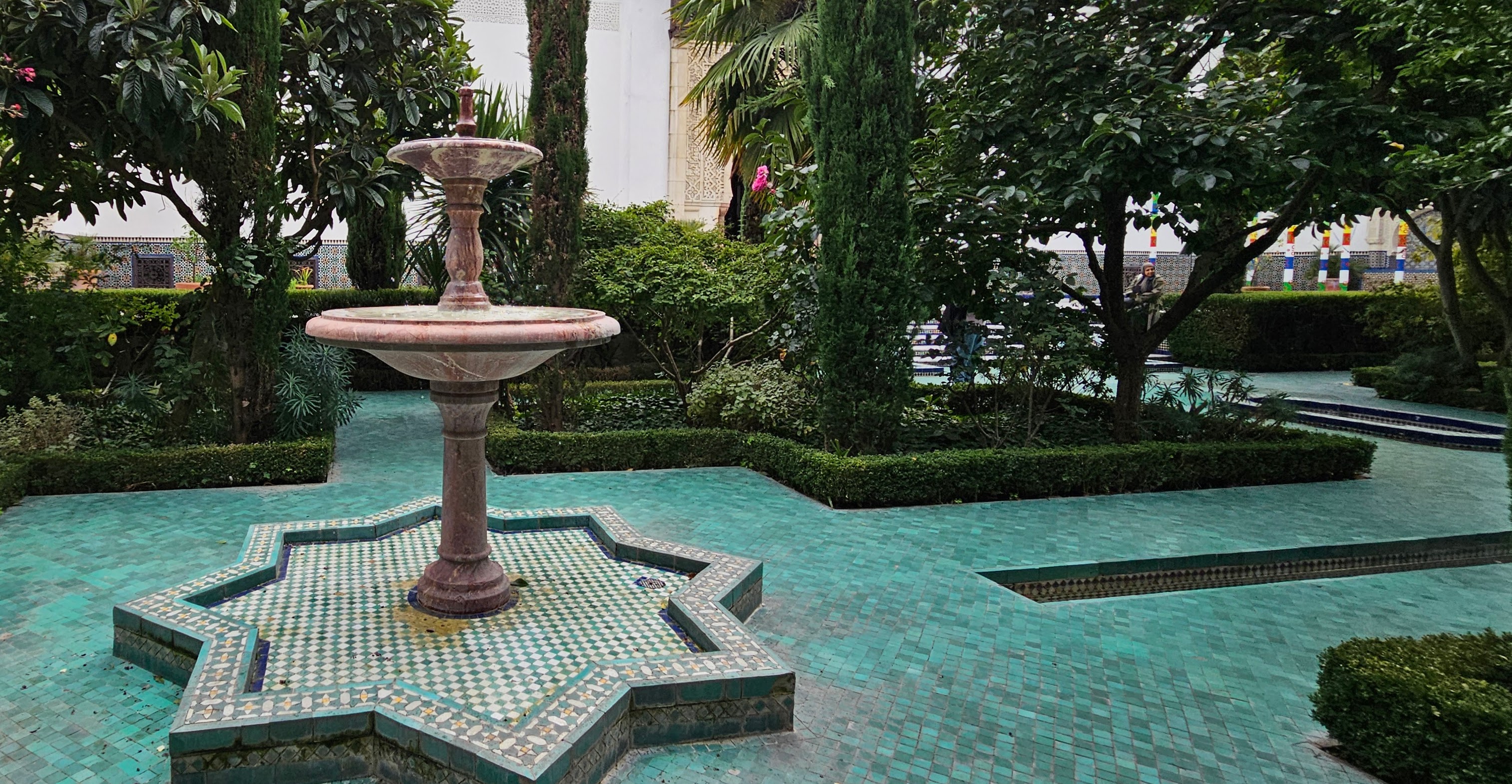Outside garden with blue tiled court looks like one big pool